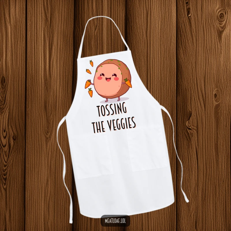 Funny apron featuring a smiling meatloaf character juggling carrots, ready for humorous kitchen performances.