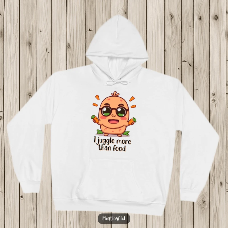 Funny meatloaf character hoodie, energetically juggling tiny carrot sticks with large, excited eyes, combining warmth and humor.