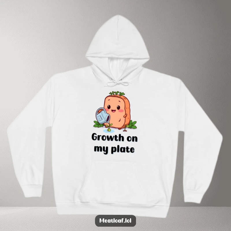 Funny growing meatloaf hoodie shows a nurturing meatloaf character watering a tiny bean sprout, radiating cozy, gardening warmth.
