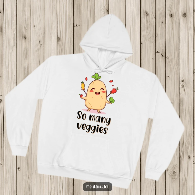 Funny hoodie featuring a giggling meatloaf character juggling tiny vegetables, blending comfort with playful, culinary skill.